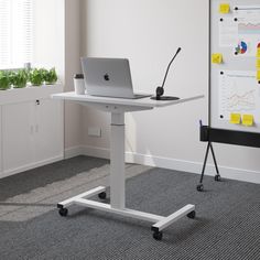 a laptop computer sitting on top of a white desk