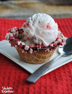 an ice cream sundae with candy canes and sprinkles on top