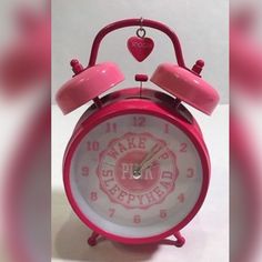 a pink alarm clock with the word fake fire department on it's face and hands