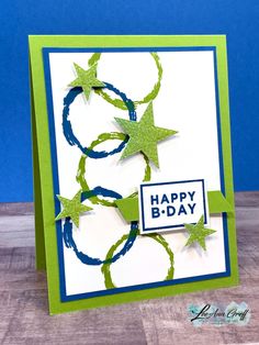 a handmade card with green and blue stars