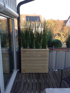 a wooden planter sitting on top of a wooden deck