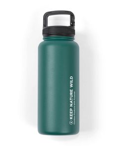 a green water bottle sitting on top of a white wall with the words keep nature wild