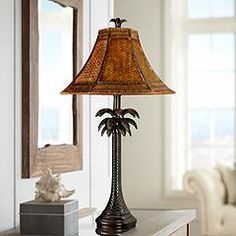 Add an island vibe to your decor with this decorative palm tree table lamp that features a rattan shade. 28" high overall. Shade is 5 1/2" across the top x 16" across the bottom x 10" high. Uses one maximum 60 watt standard-medium base light bulb (not included). On-off socket switch. Style #5R990 at Lamps Plus. West Indies Decor, Tropical British Colonial, British West Indies Style, British Colonial Decor, Beachfront Decor, Colonial Interior, Palm Tree Design, British Colonial Style, Colonial Design