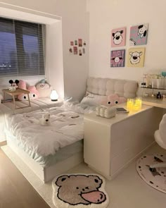 a bed room with a neatly made bed and a teddy bear rug