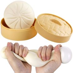 two hands holding dough in front of an egg and bread molding tray with the lid open