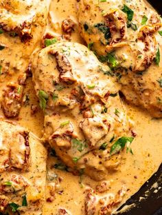 chicken with sauce and herbs in a skillet