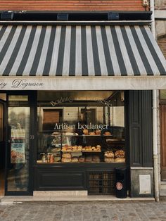 a bakery with striped awnings on the outside