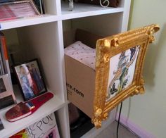 a book shelf with books and pictures on it