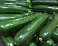 cucumbers are piled on top of each other