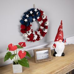 a patriotic wreath and gnome figurine on a table