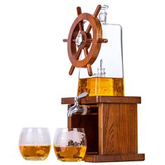 a glass filled with liquid next to a wooden ship wheel