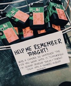 a pile of cell phones sitting on top of a metal rack next to a sign that says help me remember tonight