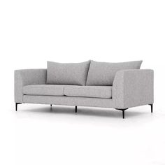 a gray couch sitting on top of a white floor