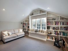 a living room filled with furniture and bookshelves next to a large open window