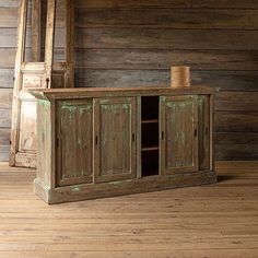 an old wooden cabinet sitting on top of a hard wood floor