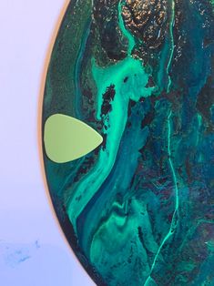 an aerial view of the earth with blue and green paint on it's surface