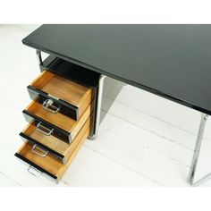 an office desk with drawers on the bottom and one drawer open to show file folders