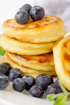 a stack of pancakes with blueberries on top