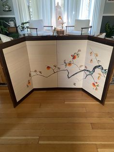 a room divider decorated with birds and flowers