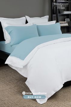 a bed with blue and white comforters in a hotel room or home bedroom area