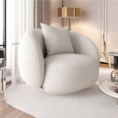 a living room with a white chair and table next to a large glass vase on the floor