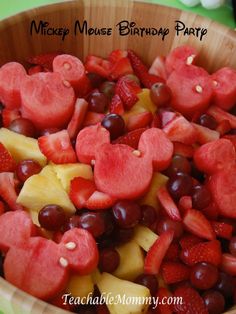 a wooden bowl filled with lots of fruit