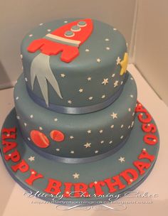 a birthday cake with a rocket ship on top