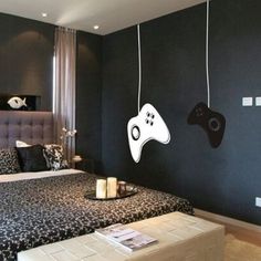 a bed room with a neatly made bed and two video game controllers on the wall