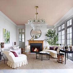 a living room filled with furniture and a fire place in the middle of a room