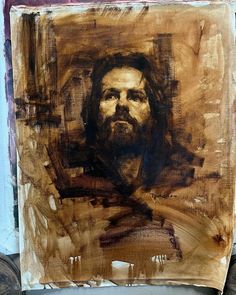 a painting of jesus on a piece of wood