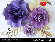 three paper flowers with gold leaves on them and one purple flower is cut out from the bottom