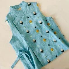 a blue top with cactus and flowers on it