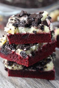 three red velvet brownies stacked on top of each other with white chocolate chips and oreo cookies