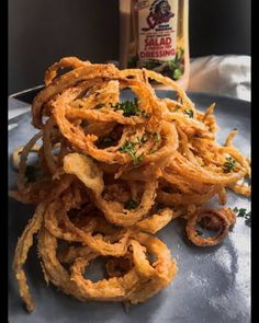 some onion rings are sitting on a plate