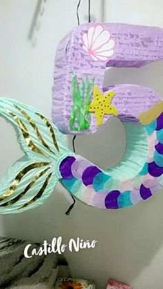 the number five is made out of paper and decorated like a mermaid's tail