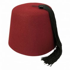 a red hat with a black tassel on the side and a white back ground