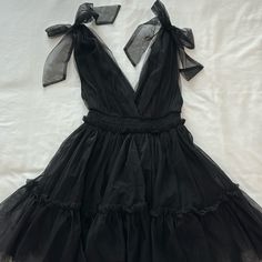 Black Tulle Mini Dress With Shoulder Bow Ties Black Tulle Mini Dress, Flirty Black Mini Dress For Prom, Black Flirty Mini Dress For Casual Wear, Black Flirty Dress For Spring, Flirty Black Dress For Spring, Black Summer Cocktail Dress, Black Mini Dress For Casual Summer Wear, Black Mini Dress For Casual Summer Days, Tulle Mini Dress