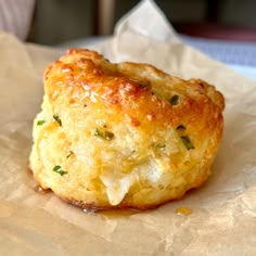 a cheesy pastry sitting on top of a piece of wax paper