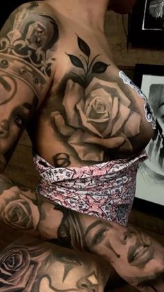 a woman with tattoos on her chest and arm is wearing a rose band around her waist