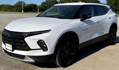 a white chevrolet suv parked in a parking lot