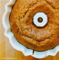 a cake in a pan with a hole in the middle and a white ring on top