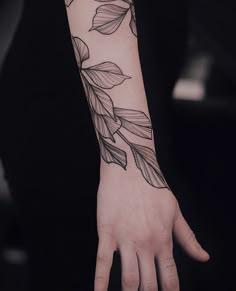 a person's hand with a tattoo on it