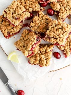 cranberry oatmeal bars on a white plate with a lemon wedge