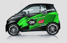 the smart car is painted green and black