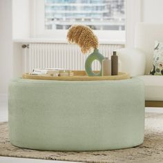 a green ottoman with some items on it