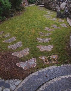 a stone path in the middle of a garden