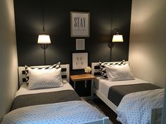 two twin beds in a small room with black and white decor