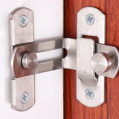 a close up of a door handle on a wooden door