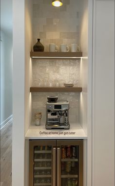 a coffee maker is sitting on top of the counter in this small kitchen with built - in shelving