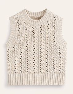 a white sweater with an open knit pattern